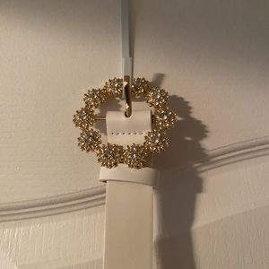 Bedazzled belt buckle with white belt